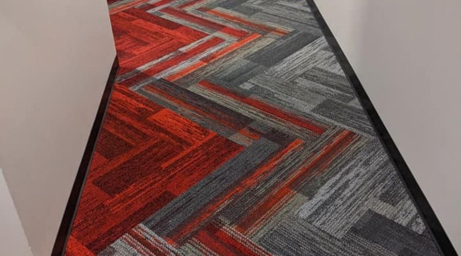 Office hallway with patterned red and grey carpet