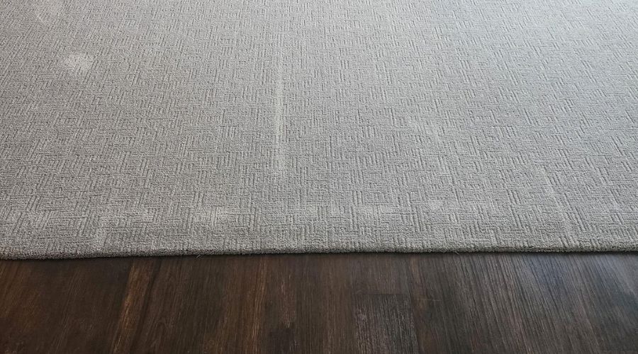 soft grey carpet in a living room with fireplace