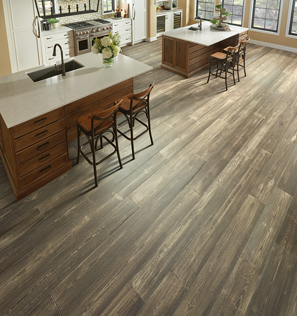 rustic hardwood flooring in a stunning large kitchen with two islands